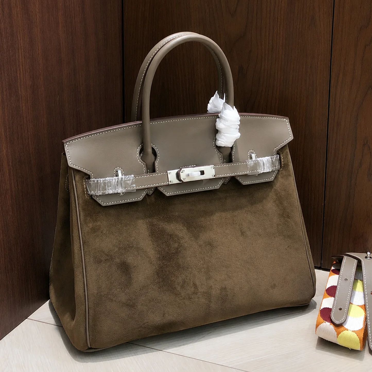 Warm Taupe Dual Texture Medium Structured Trapezoid Tote With Muted Grey Overlay And Polished Silvery Twist Lock Hardware Detail