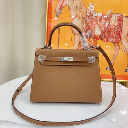 Warm Golden Tan Fine Grain Angular Structured Trapezoid Handbag With Contrast Stitching And Sleek Silvery Twist Lock Hardware