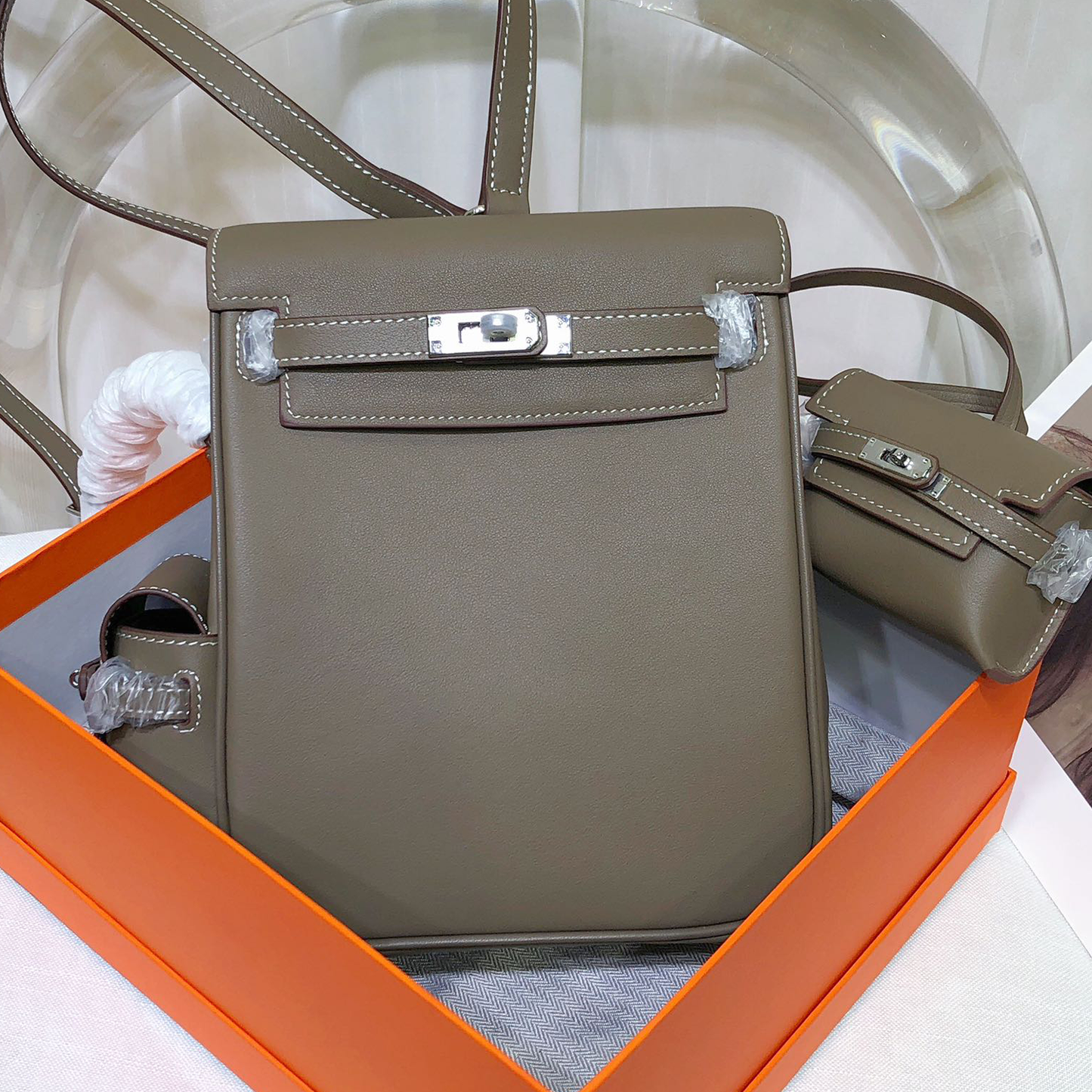 Muted Elephant Grey Vertical Flap Backpack With Pale Contrast Stitching And Side Matching Mini Accessory Pouch